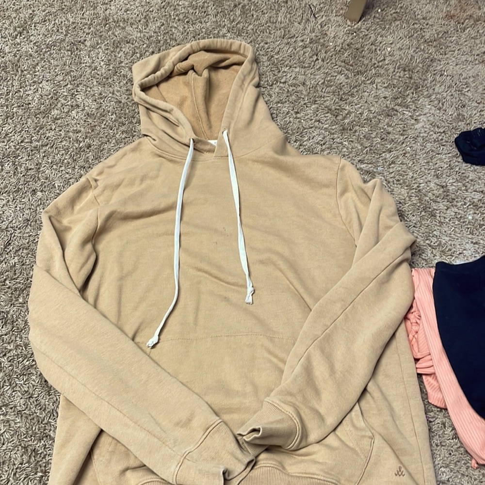 Used has three small pens stands oversized hoodie.